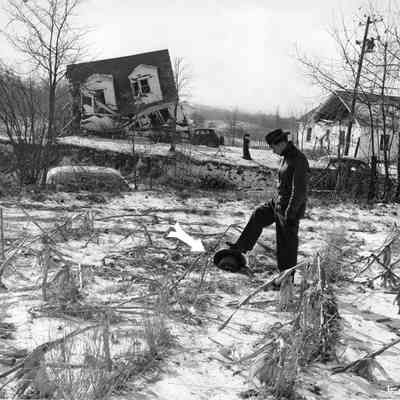 Halltown dynamite truck explosion - Bobby Seagams with foot on piece of truck wheel