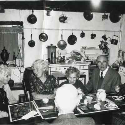 Men and women at kitchen table