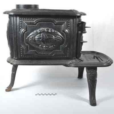 Small three legged cast iron parlor stove