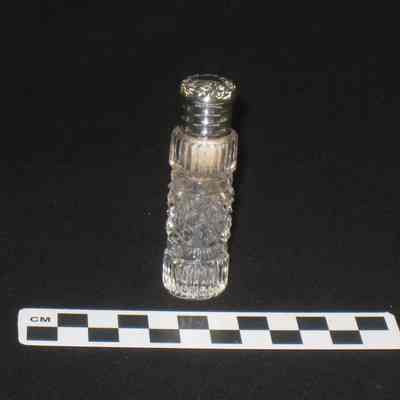 Cut glass perfume bottle with silver cap