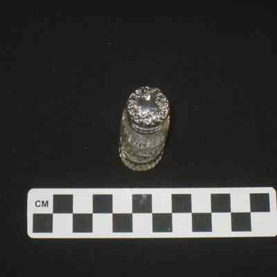 Cut glass perfume bottle with silver cap