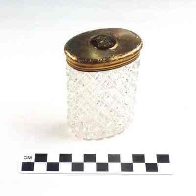 Oval cut glass bottle with gold washed cap