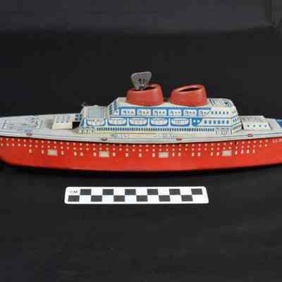 Red, white and blue tin ship