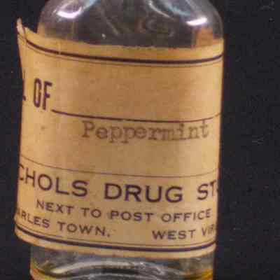 Clear glass pharmacy bottle with black plastic cap label