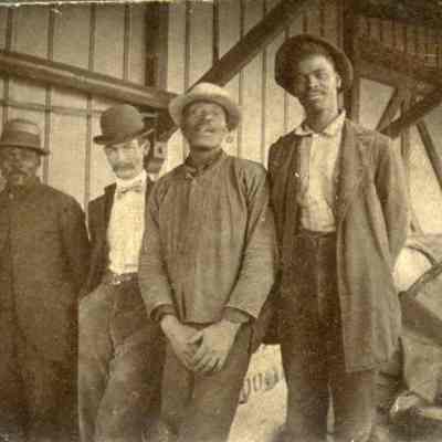 Four men in hats