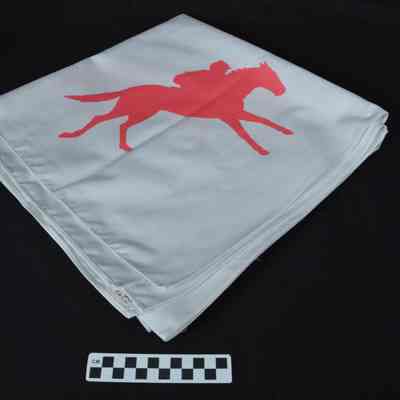 White tablecloth with red jockeys on horses
