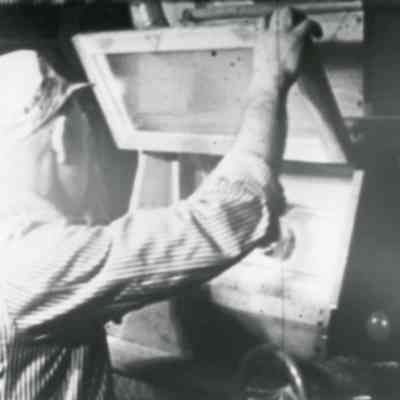Mr. "Nip" Collis supervises milling process at Peoples Supply
