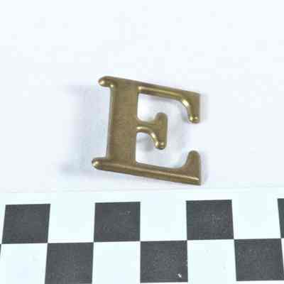 Stamped brass Company "E" hat badge