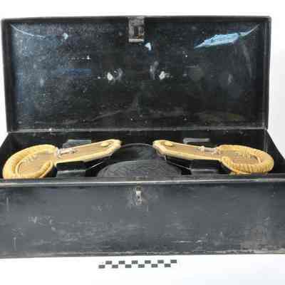 Epaulets and an admiral's hat in a black tin box