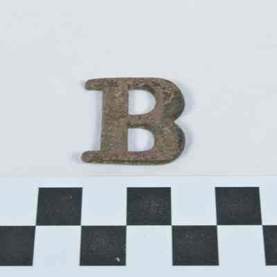 Stamped brass letter "B" for designation of a military company