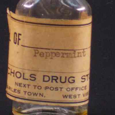 Clear glass pharmacy bottle with black plastic cap