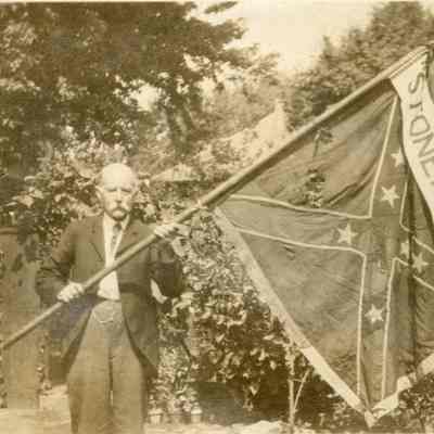 John Foley holding a Confederate battle flag
