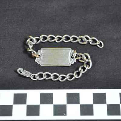 Silver colored identification bracelet with chain