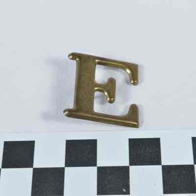 Stamped brass Company "E" hat badge