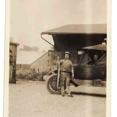 Martin D. Welsh, Sr. holding prized eel caught in the Potomac in front of Preston Millard's "company" store, Bakerton, WV, undated: IMG2025.026.001 (11)