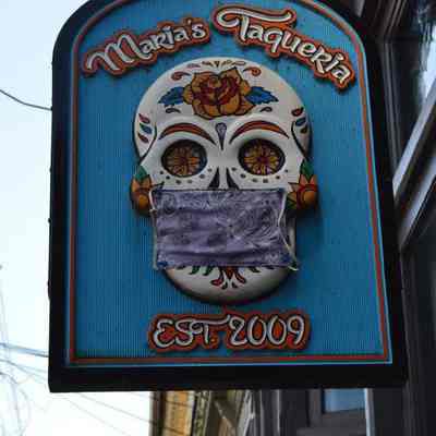 Cloth mask on sign at Maria's Taqueria