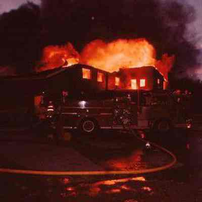 Fire engine in front of burning house