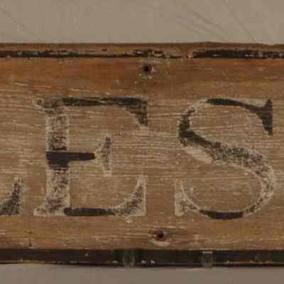 Wooden sign with "CHARLES TOWN" painted in black