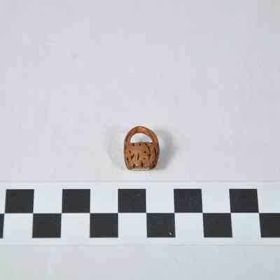 Basket carved from a peach pit