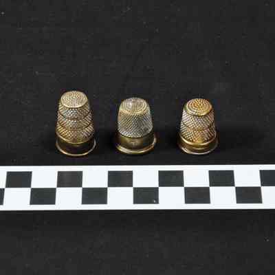 Three brass thimbles