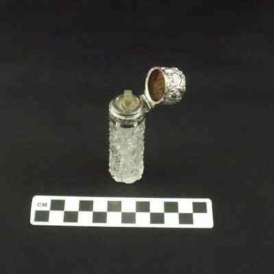 Cut glass perfume bottle with silver cap