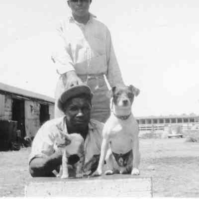 Unidentified race track stables and workers