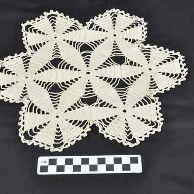Twelve napkins and one doily
