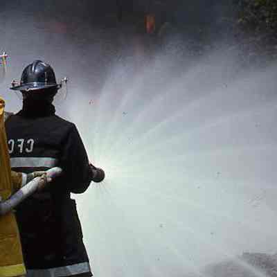 Firefighters holding hose