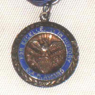 Medal with dark blue ribbon above