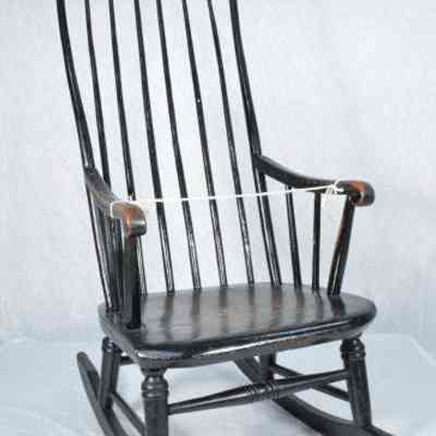Rocking chair painted brown over black paint