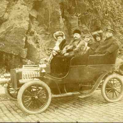 Two women and three men in an automobile, c. 1910