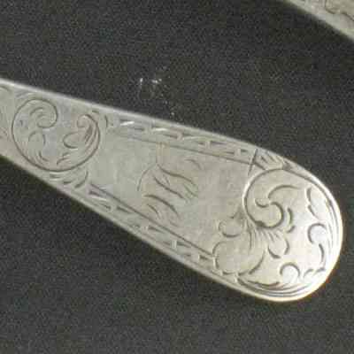 Two salt spoons with initials LH