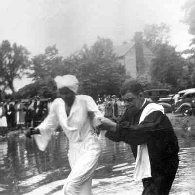 Rev. E. E. Baylor officiating at a baptism