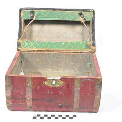 Wood trunk covered with thin red leather or Leatherette