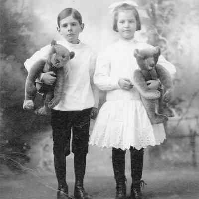 Boy and girl about 8 years of age, each holding a teddy bear