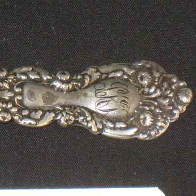 Fork with ornate floral design on handle all the way to the four tines