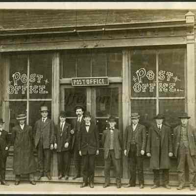 Eleven unidentified men standing in front of Post Office