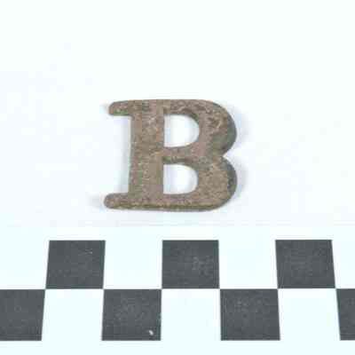 Stamped brass letter "B" for designation of a military company