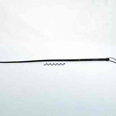 Tapered riding crop wrapped with a dark fabric