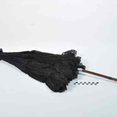 Black silk parasol trimmed with black lace
