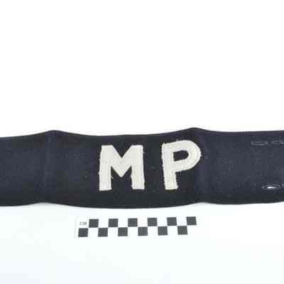 Black wool armband with white "MP" sewn on
