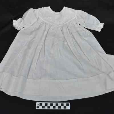 Child's white dress with simple floral pattern embroidered on bodice