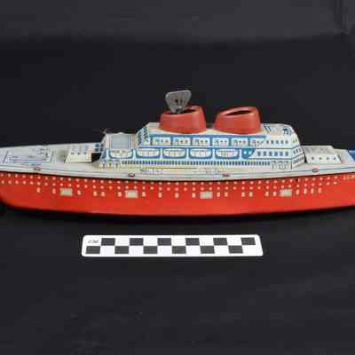 Red, white and blue tin ship and box