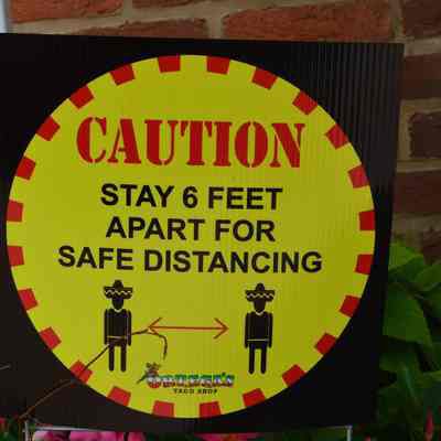 Ortega's Taco Shop and Bushel & Peck with COVID-19 pandemic signs