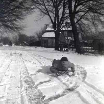 Millard Lee Jenkins sledding in Ranson, December 1945