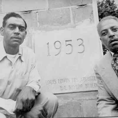 Charles and Leonard Baylor at cornerstone of building built by their father