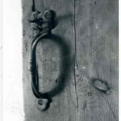 Door latch on wooden door of farmhouse