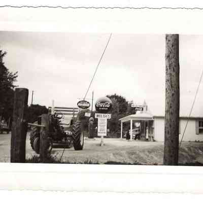 Welsh's Grocery with signs and farm equipment in front of it.: IMG2025.026.001 (38)
