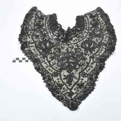 Black lace collar sewn onto a white backing