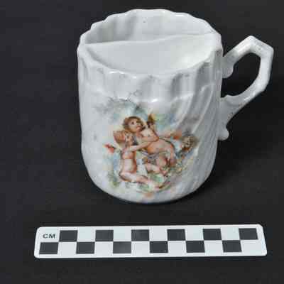 White shaving mug with decal decorations of cherubs